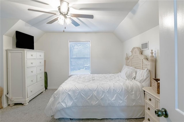 carpeted bedroom with ceiling fan and vaulted ceiling