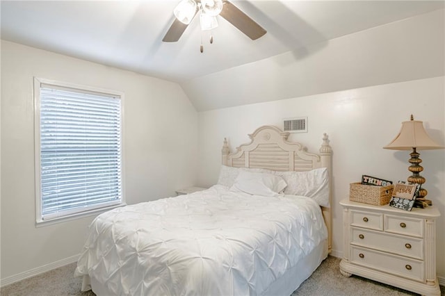 bedroom featuring lofted ceiling, multiple windows, ceiling fan, and light colored carpet