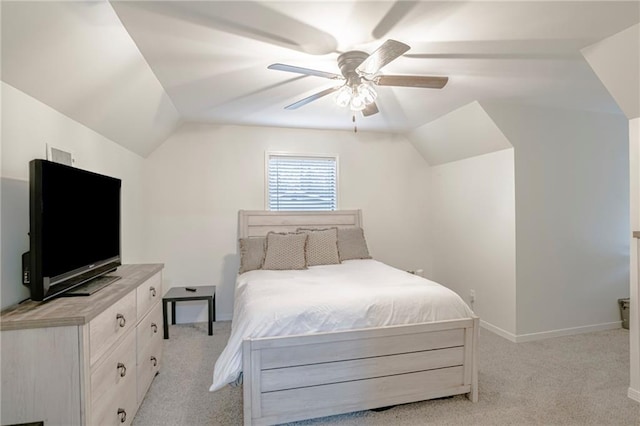 bedroom featuring ceiling fan, light carpet, and vaulted ceiling