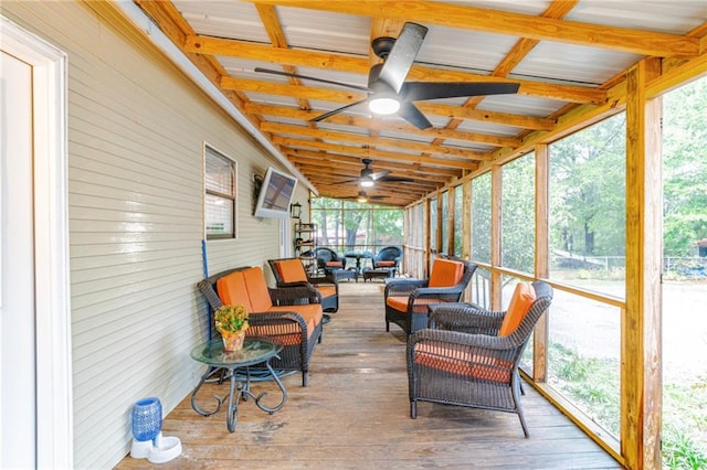 sunroom / solarium featuring ceiling fan