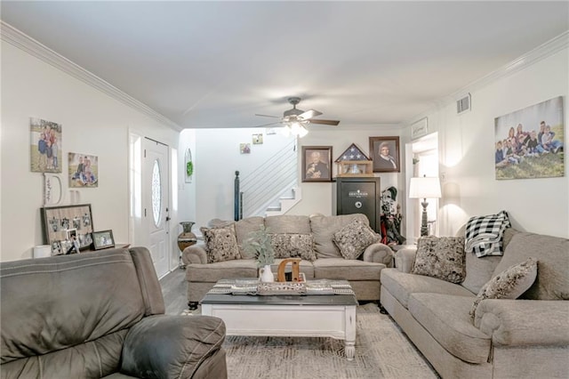 living room with ceiling fan and crown molding