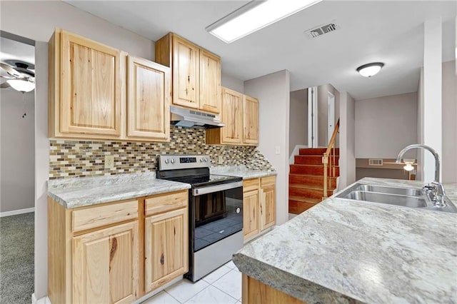 703 Townsend Cir, Chickasaw, AL 36611 - kitchen featuring stainless steel range with electric cooktop, under cabinet range hood, a sink, light brown cabinets, and decorative backsplash