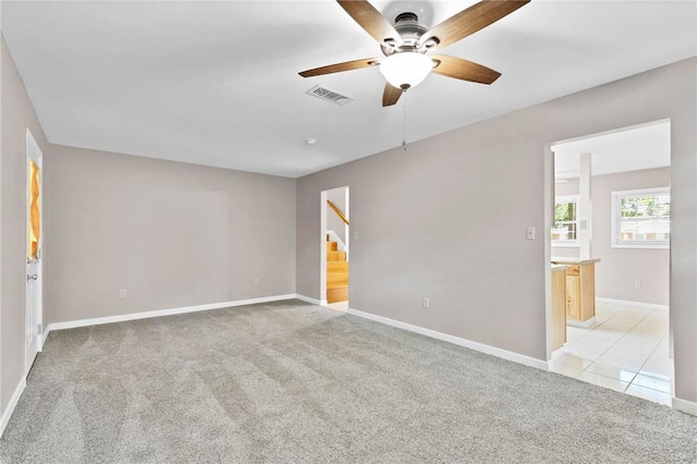 703 Townsend Cir, Chickasaw, AL 36611 - spare room featuring light colored carpet, stairs, a ceiling fan, and baseboards