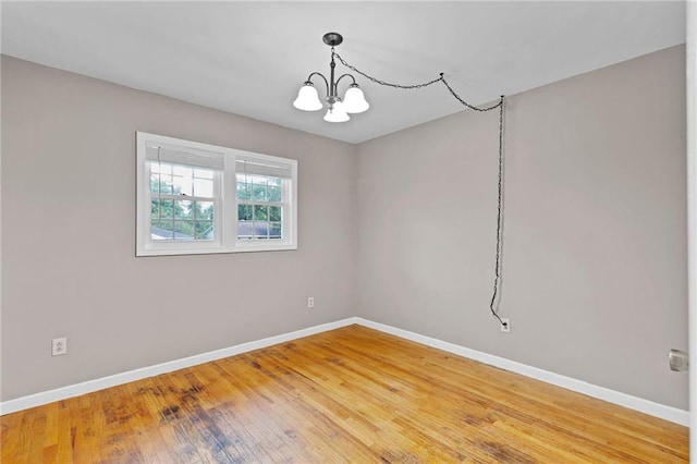 703 Townsend Cir, Chickasaw, AL 36611 - empty room featuring baseboards, a chandelier, and light wood-style flooring