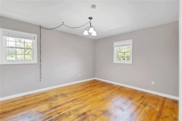 703 Townsend Cir, Chickasaw, AL 36611 - unfurnished room featuring baseboards, light wood-style flooring, a smoke detector, and a chandelier