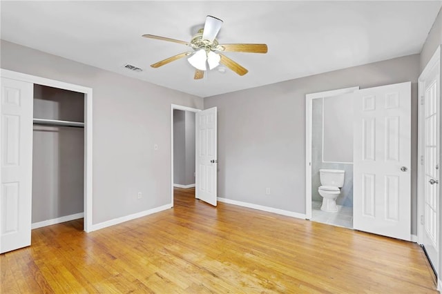 703 Townsend Cir, Chickasaw, AL 36611 - unfurnished bedroom with baseboards, a closet, light wood finished floors, and ensuite bath