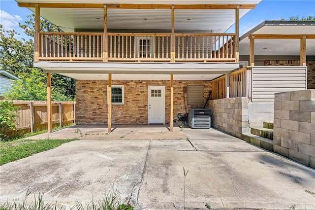 703 Townsend Cir, Chickasaw, AL 36611 - back of house featuring central air condition unit, brick siding, and a carport