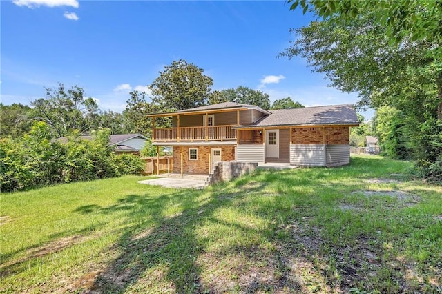 703 Townsend Cir, Chickasaw, AL 36611 - rear view of property with a patio, a yard, brick siding, and a wooden deck