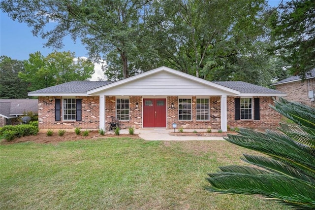 ranch-style home featuring a front yard and brick siding