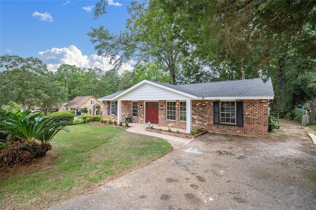 ranch-style home with brick siding and a front yard