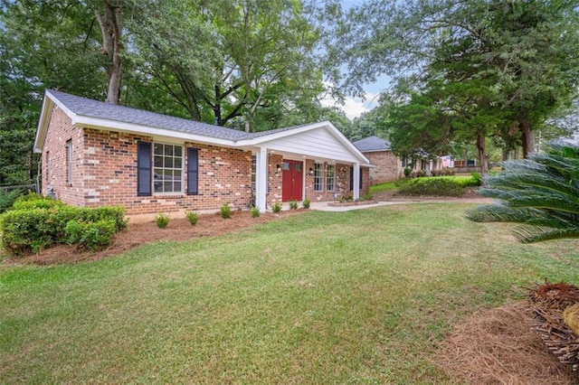 ranch-style house featuring brick siding and a front lawn