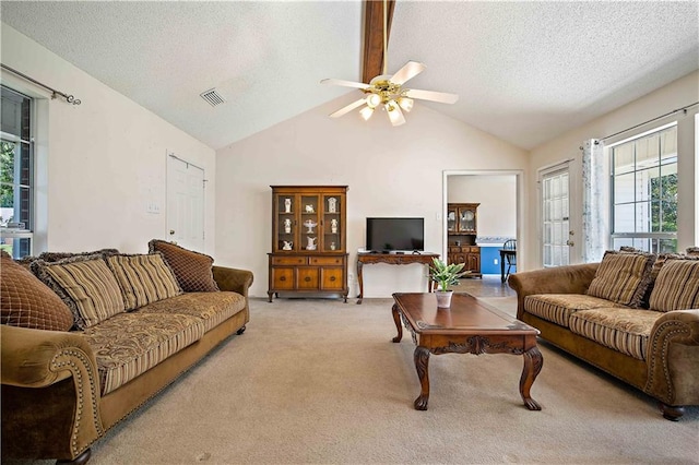 living room with light carpet, a textured ceiling, high vaulted ceiling, and ceiling fan