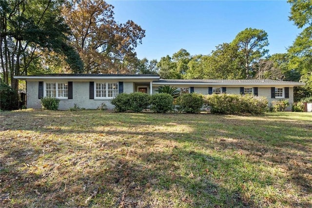 ranch-style home with a front lawn