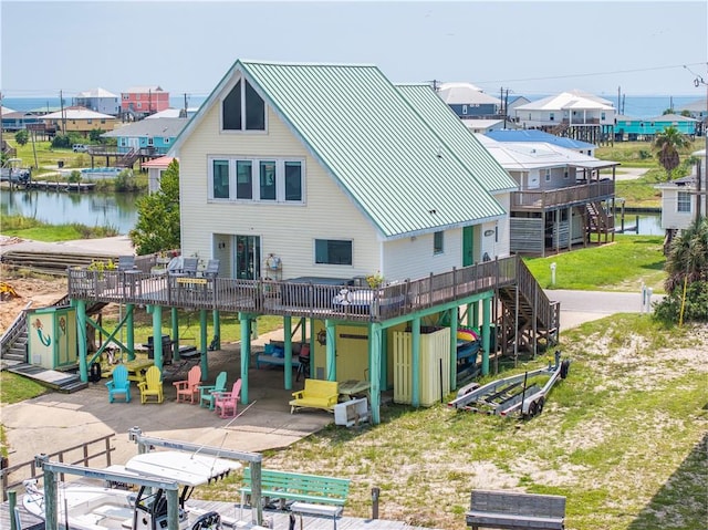 back of house featuring a deck with water view