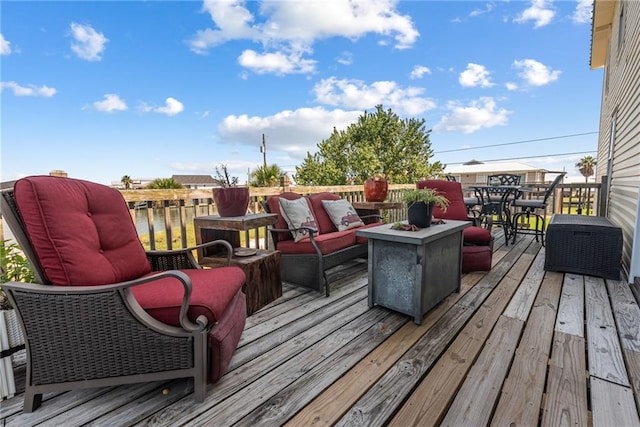 deck with an outdoor living space with a fire pit