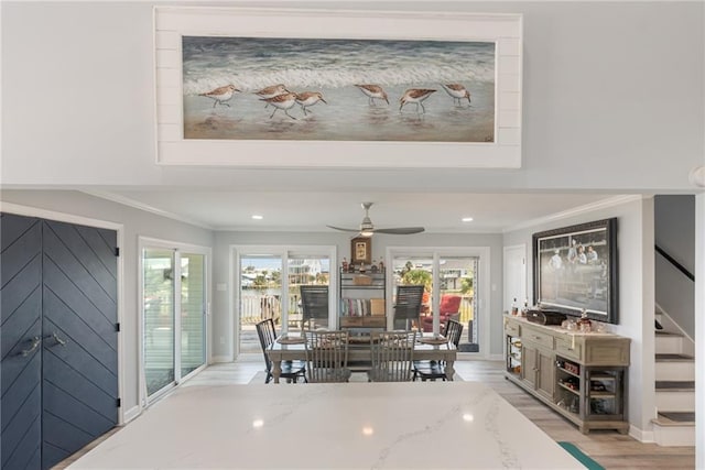 dining area featuring light hardwood / wood-style flooring, ceiling fan, and ornamental molding