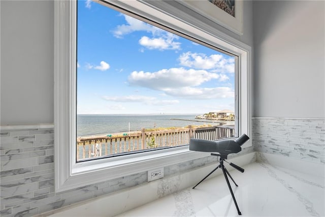 interior space with a water view and a view of the beach