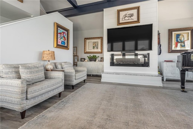 sitting room with beam ceiling, a multi sided fireplace, and dark wood-type flooring