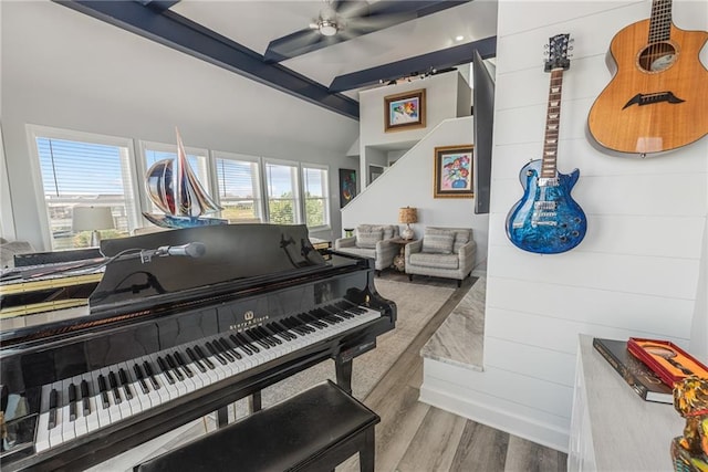 misc room with lofted ceiling with beams, ceiling fan, and light hardwood / wood-style flooring