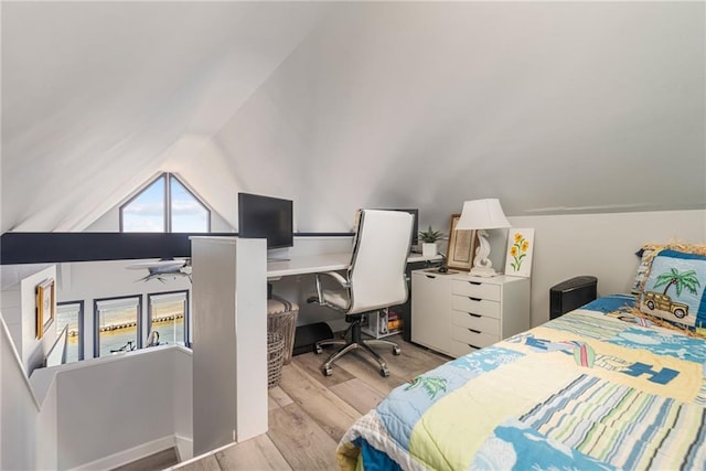 bedroom featuring light wood-type flooring and lofted ceiling