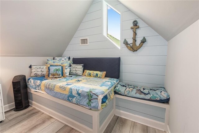 bedroom featuring light hardwood / wood-style flooring and vaulted ceiling