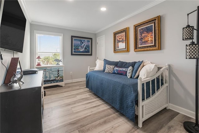 bedroom featuring light wood-type flooring and ornamental molding