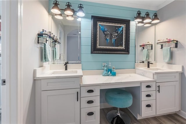 bathroom featuring vanity, hardwood / wood-style flooring, and crown molding