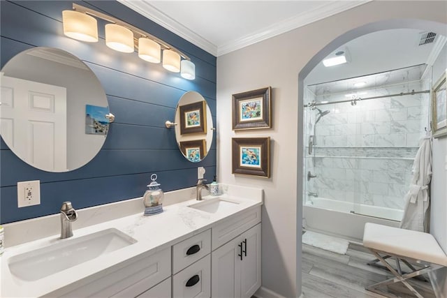 bathroom featuring vanity, hardwood / wood-style floors, tiled shower / bath, and crown molding