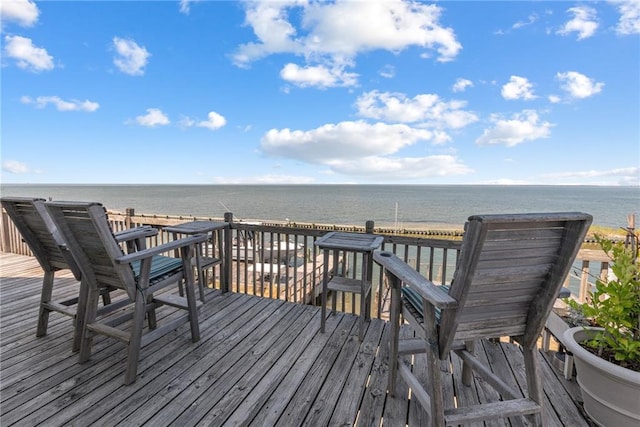 wooden terrace featuring a water view