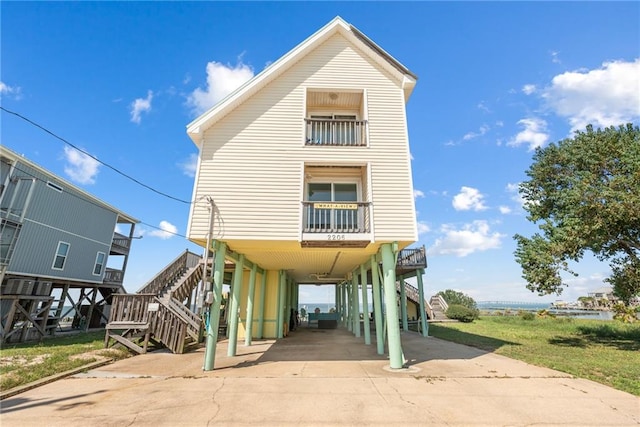 raised beach house featuring a carport