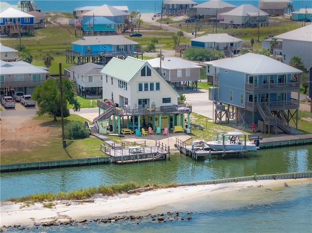 bird's eye view with a water view and a beach view