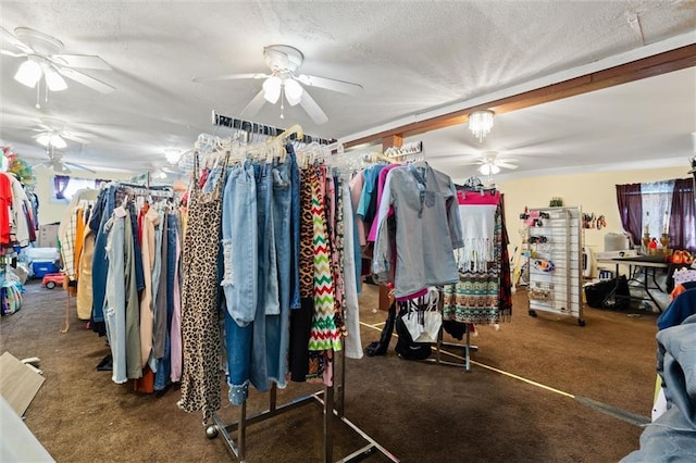 walk in closet featuring ceiling fan and dark colored carpet