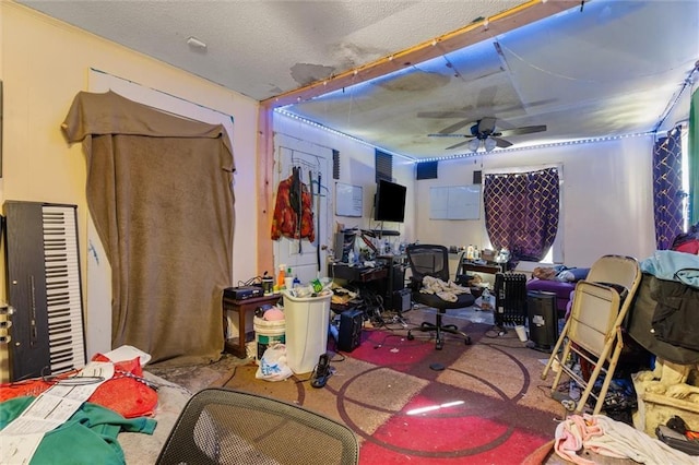 interior space with carpet, a textured ceiling, and ceiling fan