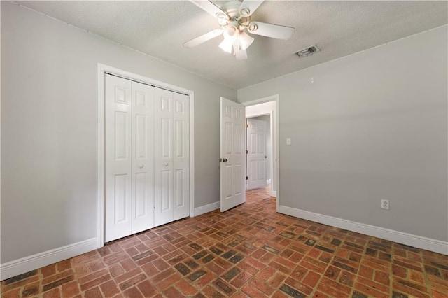 unfurnished bedroom featuring a closet, ceiling fan, and a textured ceiling