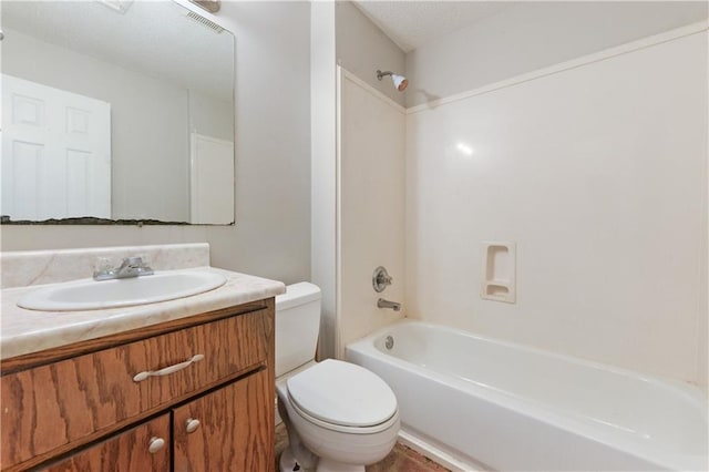 full bathroom featuring vanity with extensive cabinet space, toilet, shower / washtub combination, and a textured ceiling