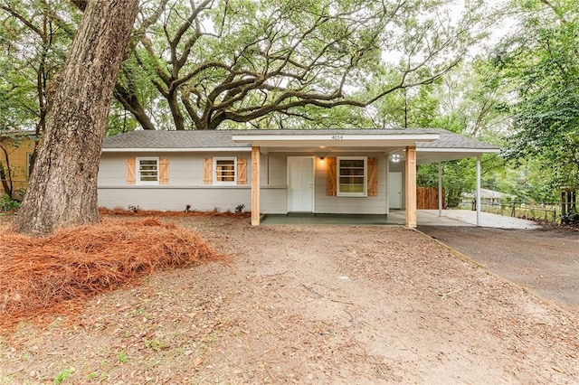 single story home featuring a carport