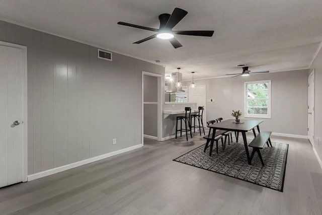 dining room with hardwood / wood-style flooring and ceiling fan