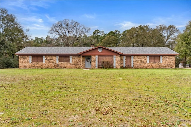 ranch-style house with a garage, a front lawn, and brick siding