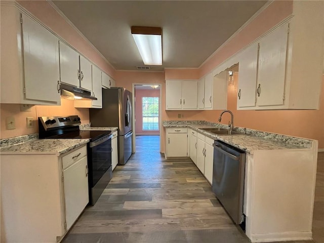 kitchen with white cabinets, crown molding, hardwood / wood-style floors, stainless steel appliances, and sink