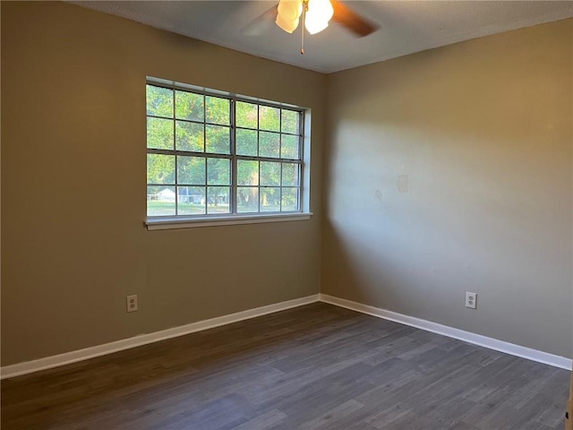 spare room featuring ceiling fan and dark hardwood / wood-style floors