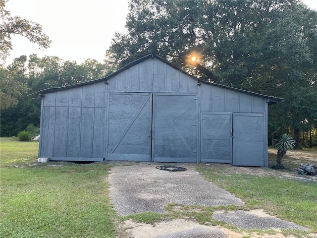 view of outbuilding featuring a lawn