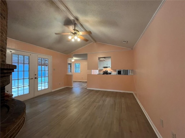 unfurnished living room with ceiling fan, a textured ceiling, wood-type flooring, and vaulted ceiling with beams