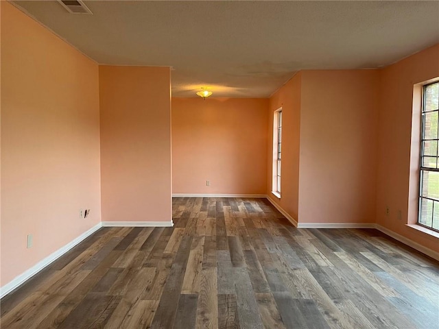 spare room featuring wood-type flooring