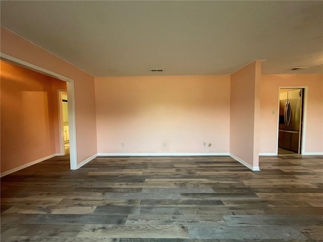 unfurnished room with hardwood / wood-style floors