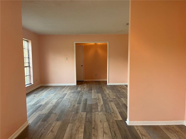 unfurnished room with wood-type flooring