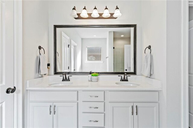 bathroom with vanity and a shower with shower door