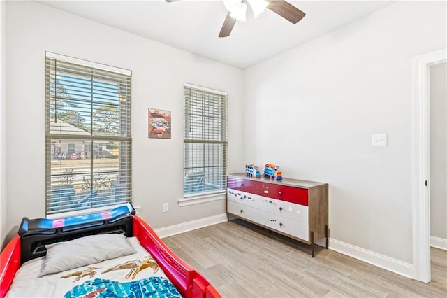 bedroom with ceiling fan and light wood-type flooring