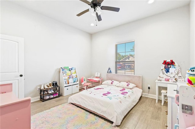 bedroom with ceiling fan and light hardwood / wood-style flooring