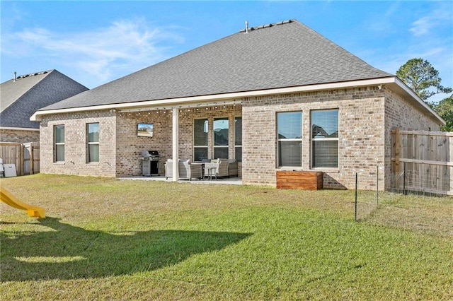 rear view of property featuring a yard and a patio