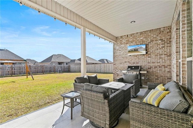 view of patio / terrace featuring a grill, an outdoor living space, and an outdoor kitchen